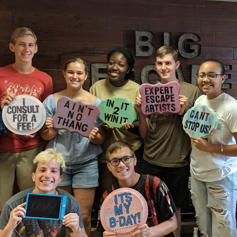 ExploreLLC students displaying their various team building signs